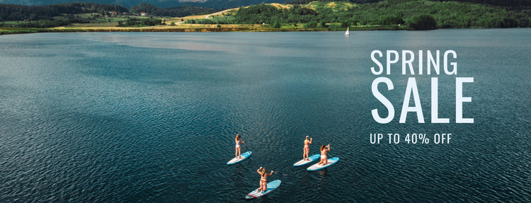 Enthusiasts paddleboarding on a serene lake using Newell's high-performance inflatable SUPs.
